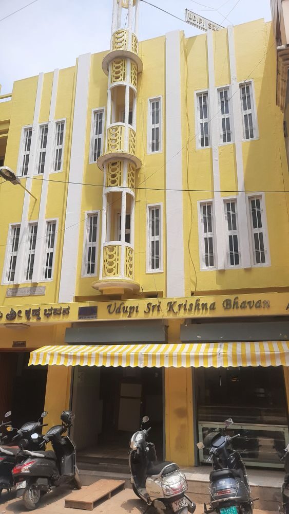 An eye-catching, beautifully maintained three-storey building in a pleasing custard yellow