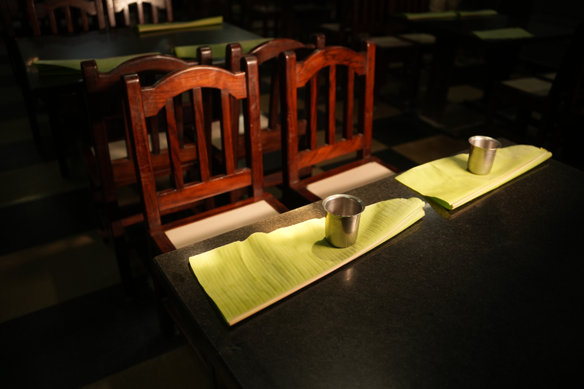 The granite-topped tables and the sensible, straight-backed wooden chairs