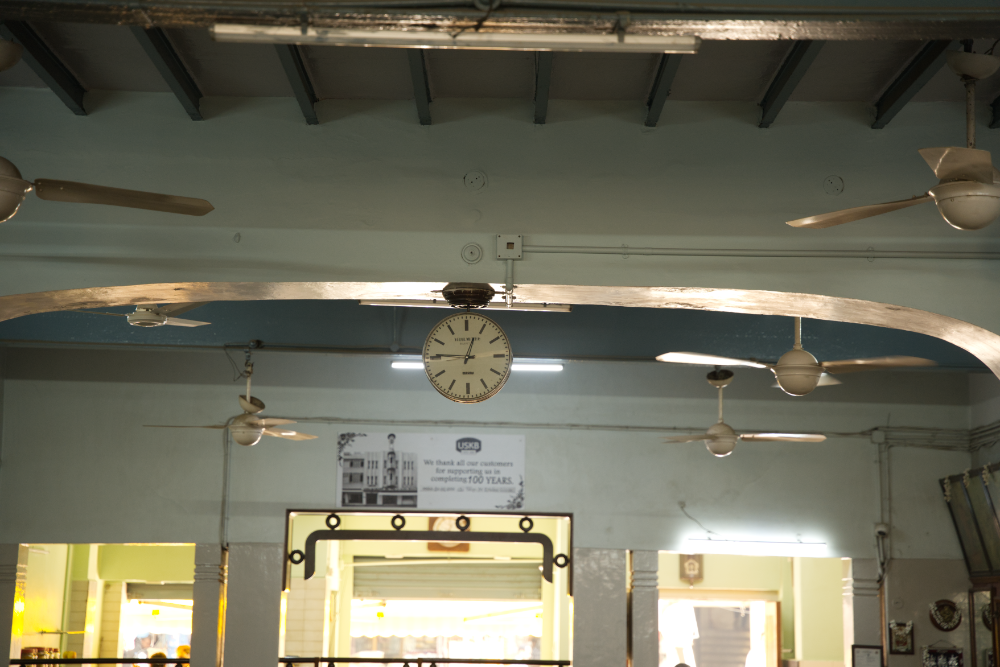 The two-faced vintage hanging clock dispassionately marking time